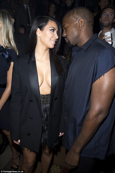 Kim Kardashian appears topless under open tuxedo jacket  